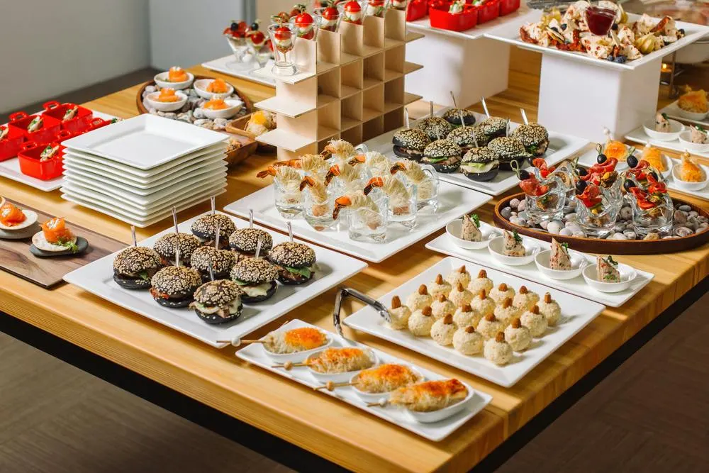 Elevated hors d'oeuvres spread with mini sliders, shrimp cocktail cups and canapés